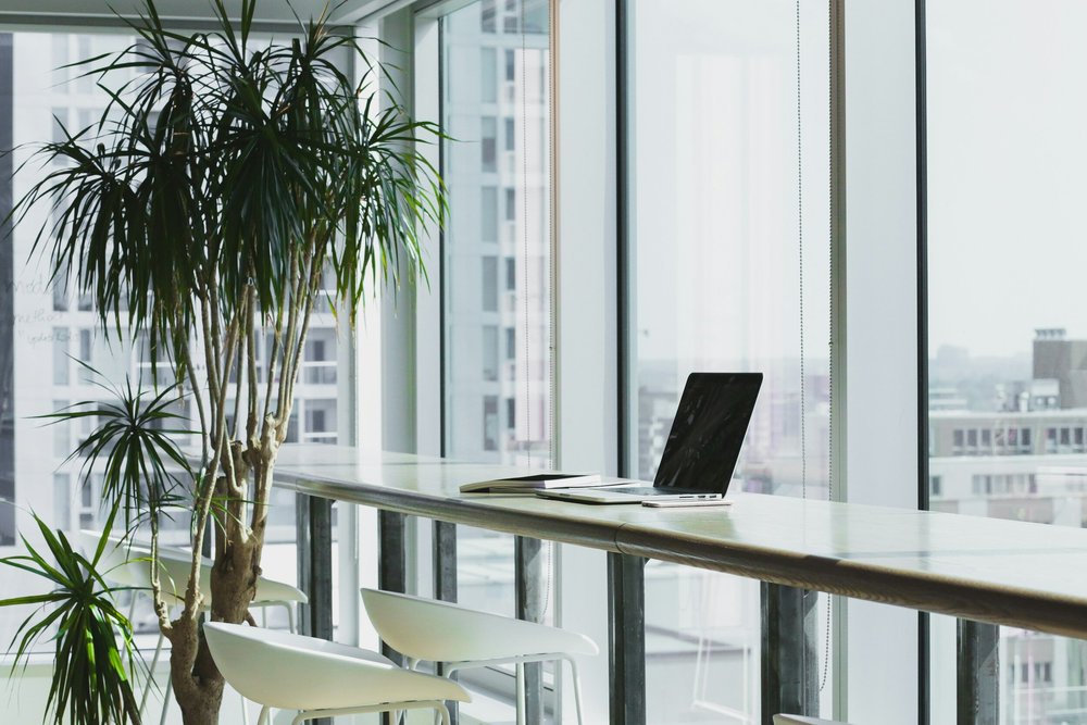 A bright workspace with a computer beside a window